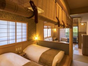 1 dormitorio con 2 camas en una habitación con ventanas en Suiun, en Hakone