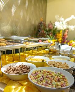 
a buffet table filled with plates of food at Luxus Grand Hotel in Lahore
