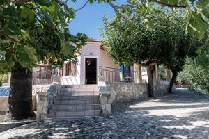 a house with stairs in front of a building at Lila hill house in Stalos