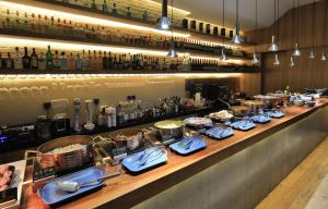 a bar with a buffet of food and drinks at EBO Hotel Hangzhou Wulin in Hangzhou
