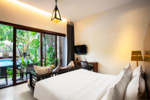 Tempat tidur dalam kamar di Apsara Residence Hotel