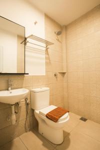 La salle de bains est pourvue de toilettes, d'un lavabo et d'un miroir. dans l'établissement HOTEL CIQ, JALAN TRUS, à Johor Bahru