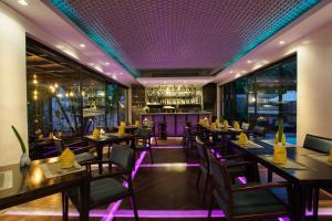 a restaurant with tables and chairs and a bar at Apsara Residence Hotel in Siem Reap