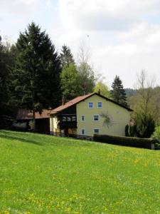 a white house with a painting on the side of it at Haus am Wald in Bad Koetzting