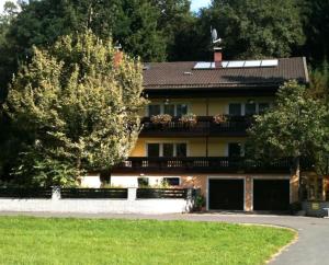 a large house with a balcony on top of it at Haus am Wald in Bad Koetzting