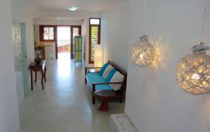 a living room with a blue couch and a table at Casa Azul in Pipa