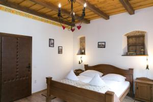 a bedroom with a bed with white pillows at Casa Richter- Check-in Independent in Sighişoara