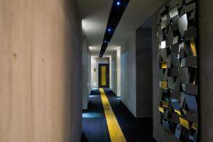 a hallway with a yellow stripe on the wall at Le Dream Boutique Hotel in George Town