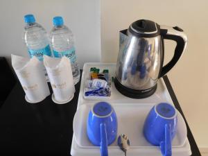 a tea kettle and two bottles of water on a tray at Maya Heritage in Bodh Gaya