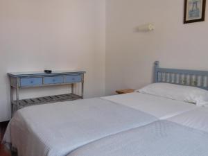 a bedroom with two beds and a blue table at Hotel Caleta in Lloret de Mar
