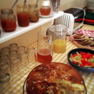 a table with a plate of food and glasses of juice at Panorama Apartments updated with infinity pool in Agios Nikolaos