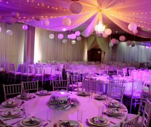 a room filled with tables and chairs with purple lighting at Crown Hotel in Ladysmith