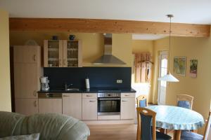 a kitchen with a table and a stove top oven at Ferienhaus Nachtigall in Rechlin