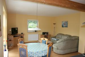 a living room with a couch and a table at Ferienhaus Nachtigall in Rechlin