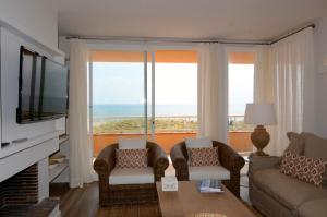 a living room with a view of the ocean at Golf Mar II G 1-2 in Pals