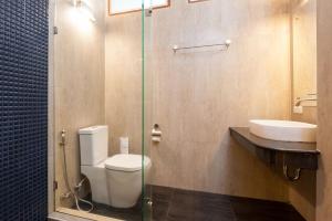 a bathroom with a toilet and a sink at Montalay Beach Resort - SHA Plus in Ko Tao