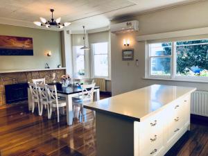 a kitchen and dining room with a table and chairs at Riverbank villa in Devonport