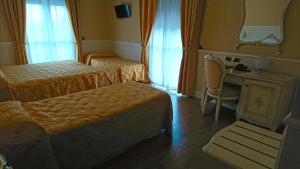 Postel nebo postele na pokoji v ubytování Hotel Confine