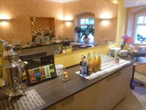 a kitchen with a counter with bottles on it at Hotel Wehlener Hof in Stadt Wehlen