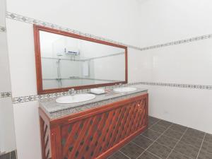 a bathroom with two sinks and a large mirror at Oxalis Home in Phong Nha