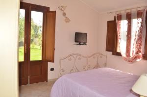 A bed or beds in a room at Agriturismo S´Aranada