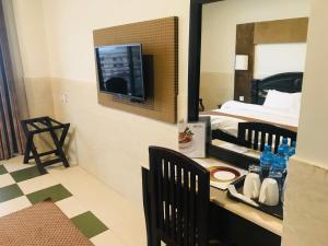 a hotel room with a television and a bed at Hotel One Mall Road Murree in Murree
