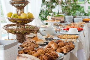 a buffet of bread and pastries on a table at Hotel Villa Melodie - Adults Only in Ischia