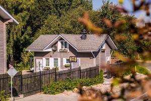 a small house with a fence in front of it at Seasons in Drozdava