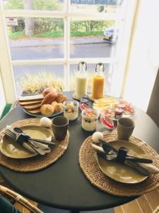 a table with plates and utensils on a table with food at B&B No. 42 in Valkenburg +17 photos
