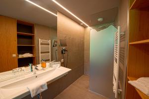 a bathroom with a large sink and a shower at Landhotel Das Stocker in Vorderstoder +39 photos