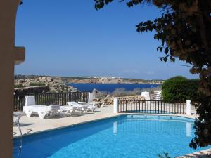 a swimming pool with a view of the water at Apartamentos Arco Iris in Punta Grossa