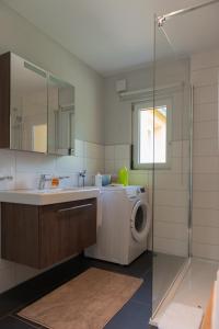 a bathroom with a washing machine and a sink at An der Günz in Waldstetten +13 photos