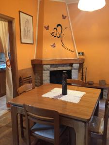 a dining room with a table and a fireplace at La casa di Ale. Foligno in Colfiorito