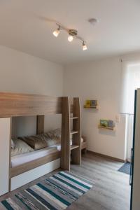 a room with bunk beds and a rug at An der Günz in Waldstetten