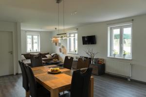 a dining room and living room with a table and chairs at An der Günz in Waldstetten