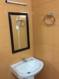 a bathroom with a sink and a mirror on the wall at Sun Shine in Chennai +19 photos