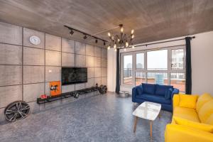 a living room with a yellow couch and a tv at Dalian Jinzhou·Baisheng Shopping Mall· Locals Apartment 00165460 in Jinzhou