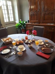 a table with a table cloth with food on it at Le Parc des Aubiers in Brion