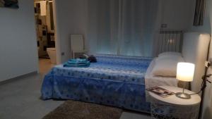 a bedroom with a blue bed with a table at Casa Dell'Artista 2 in Salerno