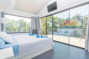 a bedroom with a bed and a large window at Finca Son Baulo in Santa Margalida