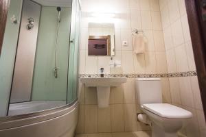 a bathroom with a toilet and a sink and a shower at Russkiy dvor in Izhevsk