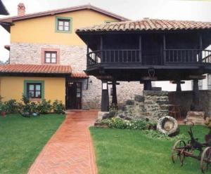 a house with a balcony on the front of it at La Fonte in Naves