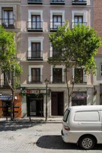 マドリードにあるRoyal Apartment Gran Vía.の建物前に停車する白いバン