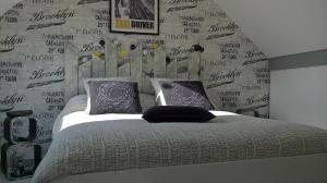 a bedroom with a bed and a wall with writing on it at Hébergements indépendants chez l'habitant in Saint-Mars-dʼOutillé