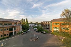 an aerial view of a parking lot in front of buildings at Deluxe Apartments By Heathrow in Harmondsworth