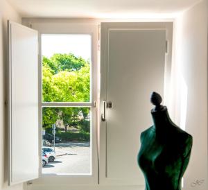 a statue of a dress in front of a door at Casa Porta D`Aviz in Évora