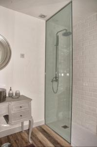 a glass shower in a bathroom with a sink at Casa Porta D`Aviz in Évora