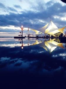 a group of white umbrellas sitting on top of the water at The Crescent Beach Hotel in Baku