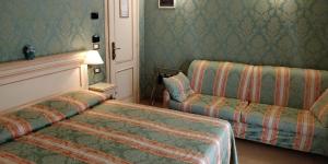 Postel nebo postele na pokoji v ubytování Hotel Villa Delle Palme