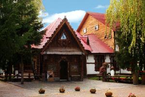 a large wooden house with a red roof at Комплекс відпочинку "Колиба" in Korostenʼ